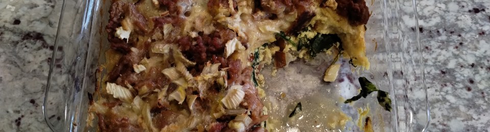 A glass pan with 3/4 of a breakfast casserole in it